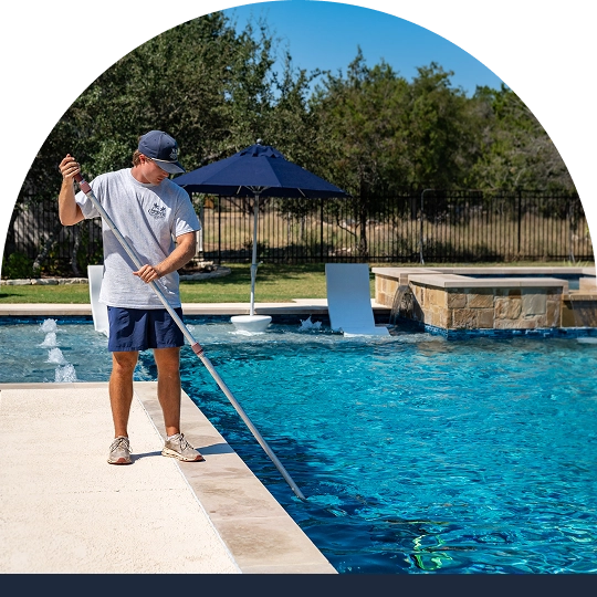 Person cleaning a pool